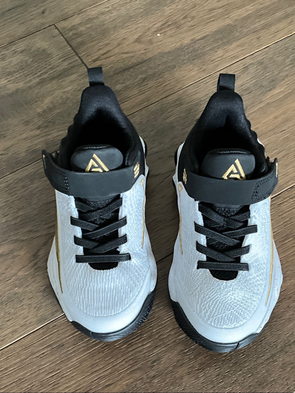 Nike Kids White and Black Sneakers with Gold Accents